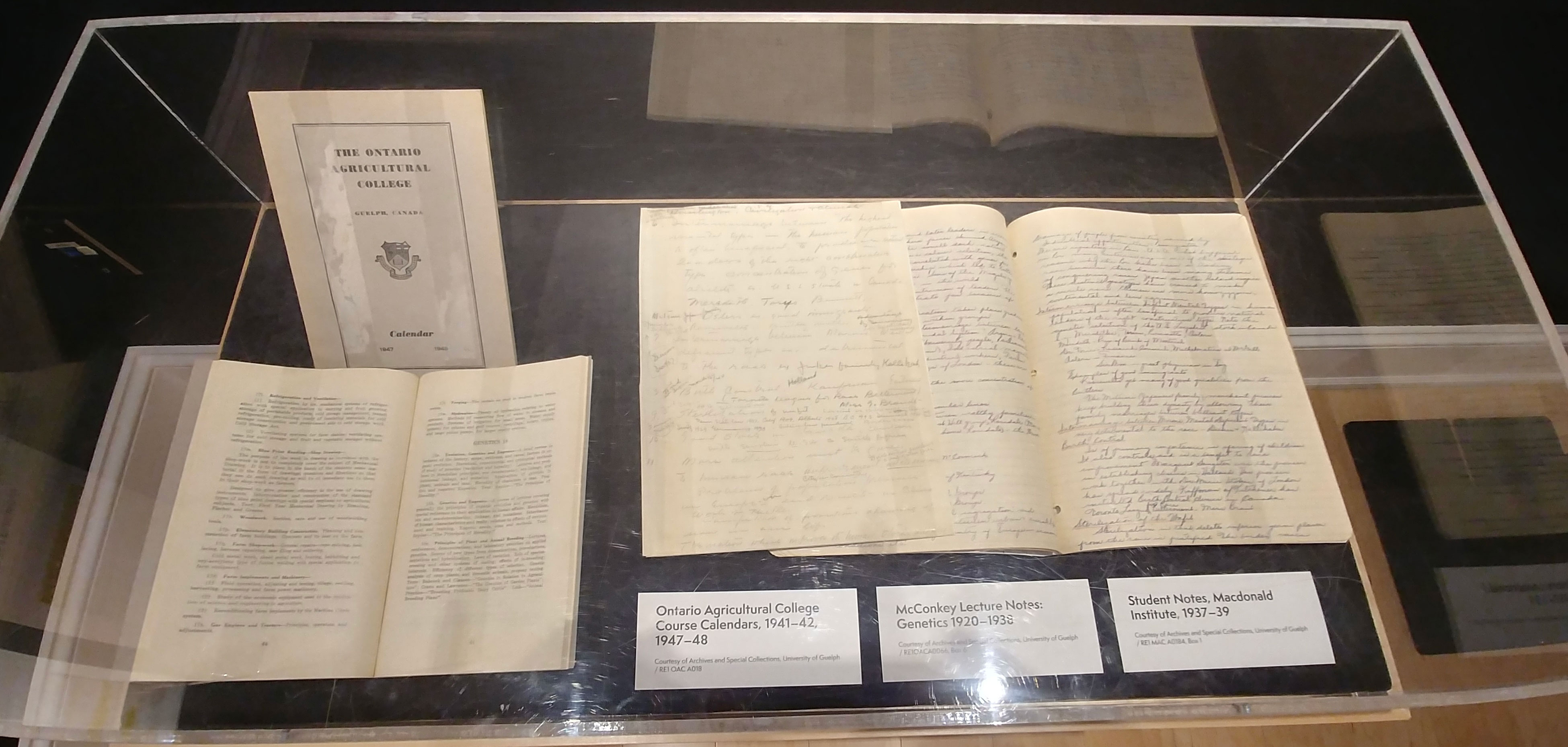 A book and notes in a glass case
